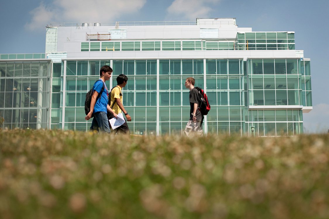 Students walk past the Physical Sciences Building at Cornell.