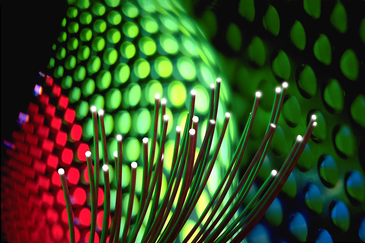 abstract image showing fiber optics, and circles of green and red light.