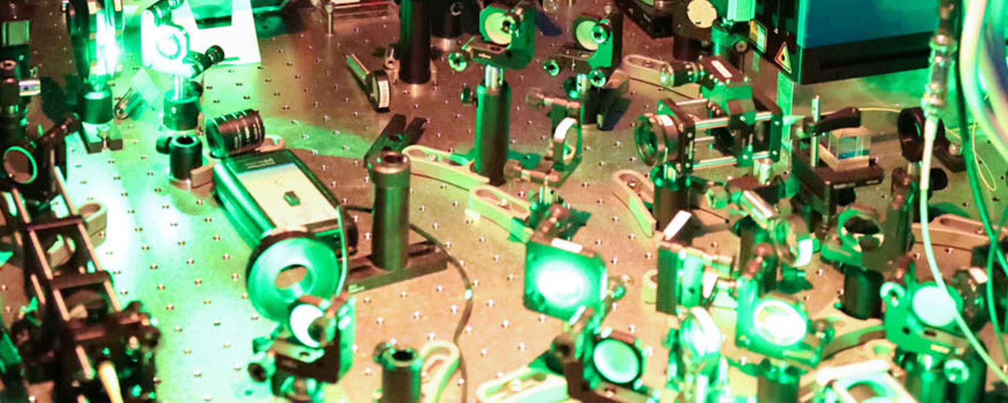 Closeup of laser optical equipment set up on a table