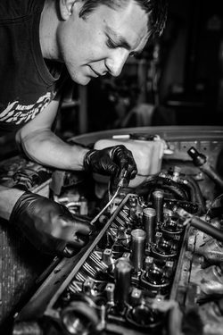 Ivan Temnykh AEP 2008 graduate, works on a car engine in his shop.