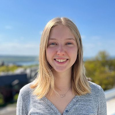 A portrait of a smiling woman with shoulder-length outside