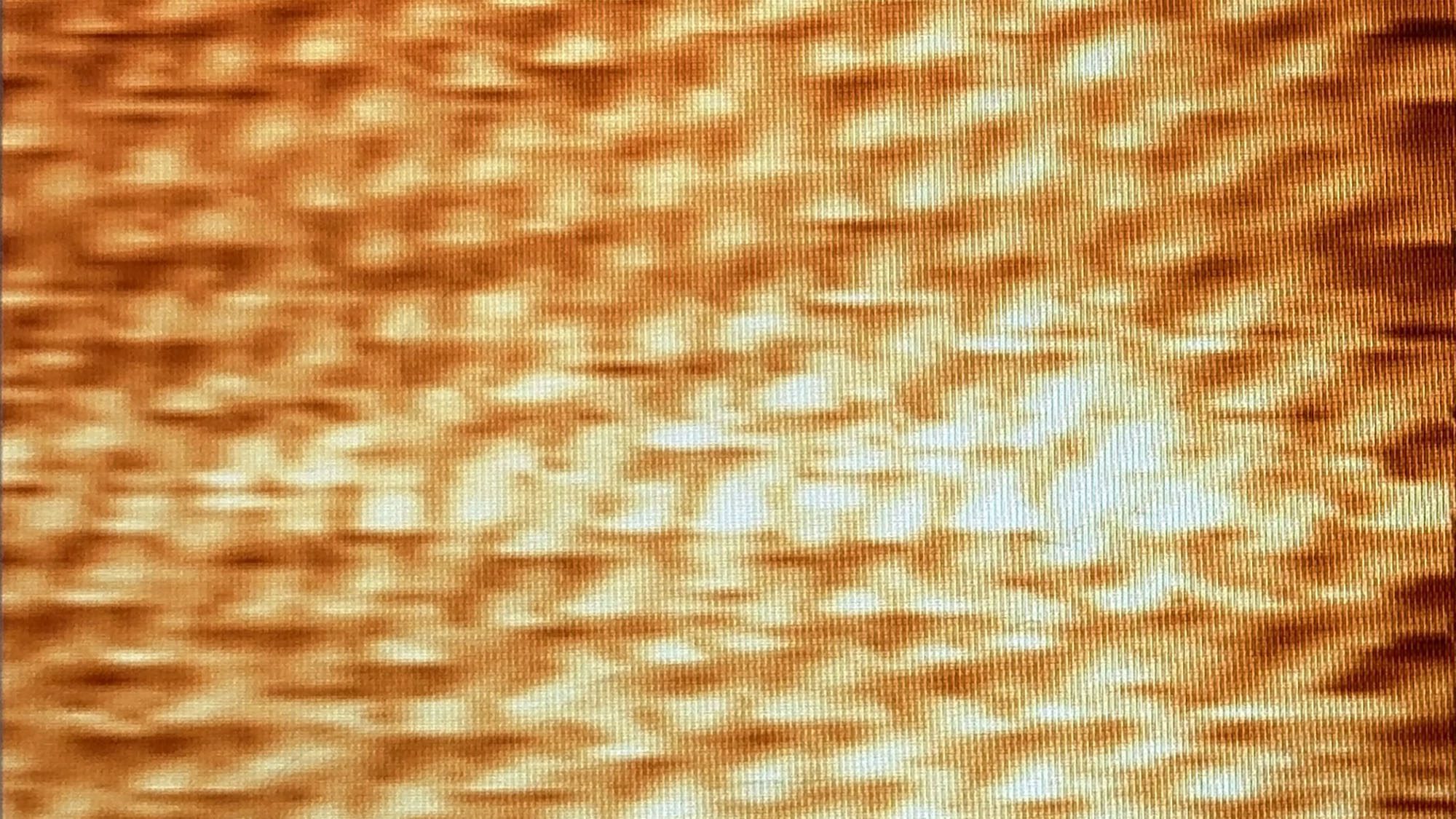 Closeup of image from atomic force microscope--whitish dots on an orange background