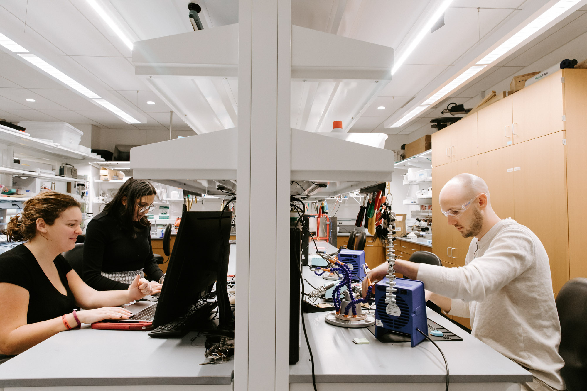 Three students work on their projects in the BME M.Eng. project teams space.