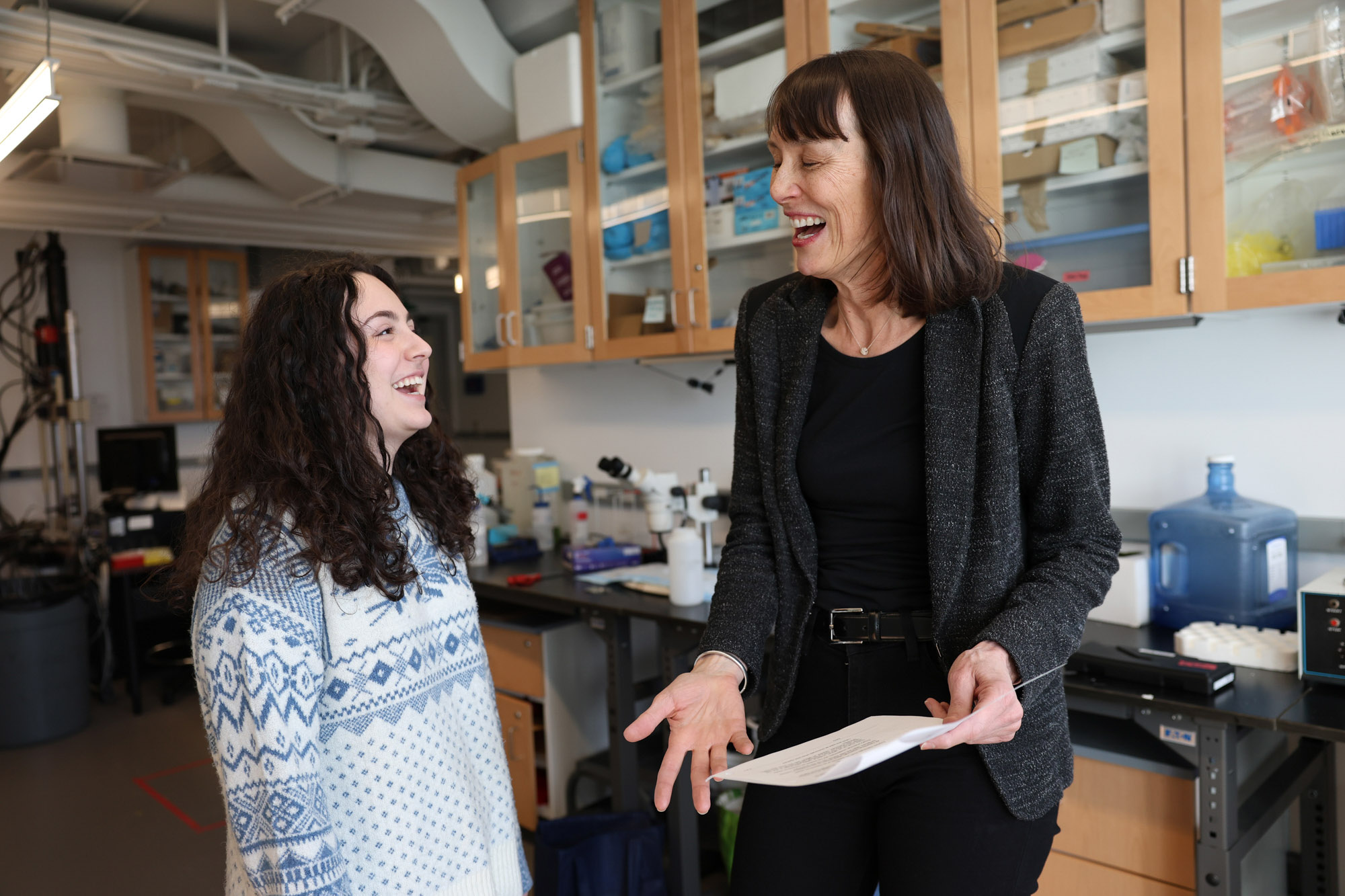 Professor Marjolein Van Der Meulen and a student laugh in the lab.