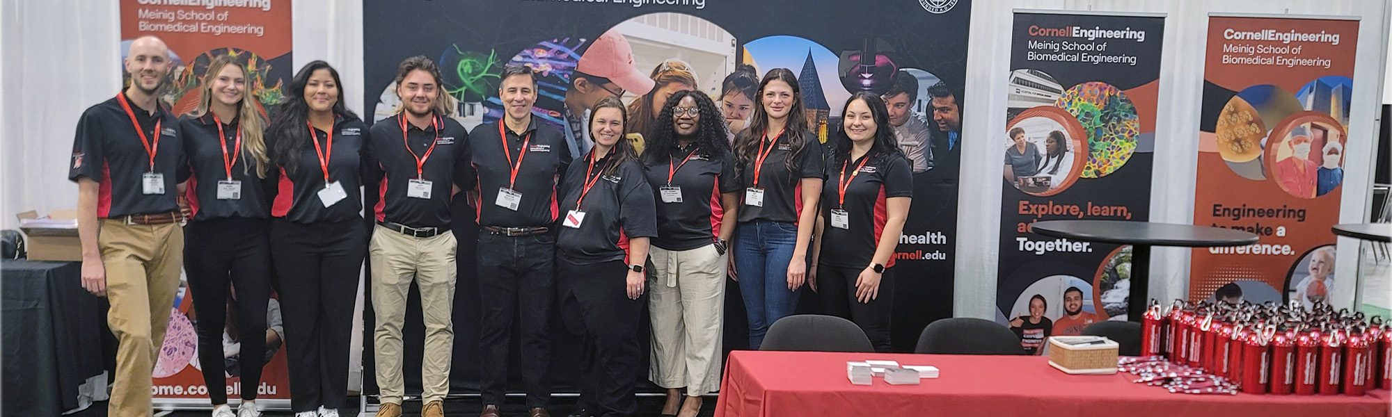 Students and faculty stand together at BMES annual meeting booth