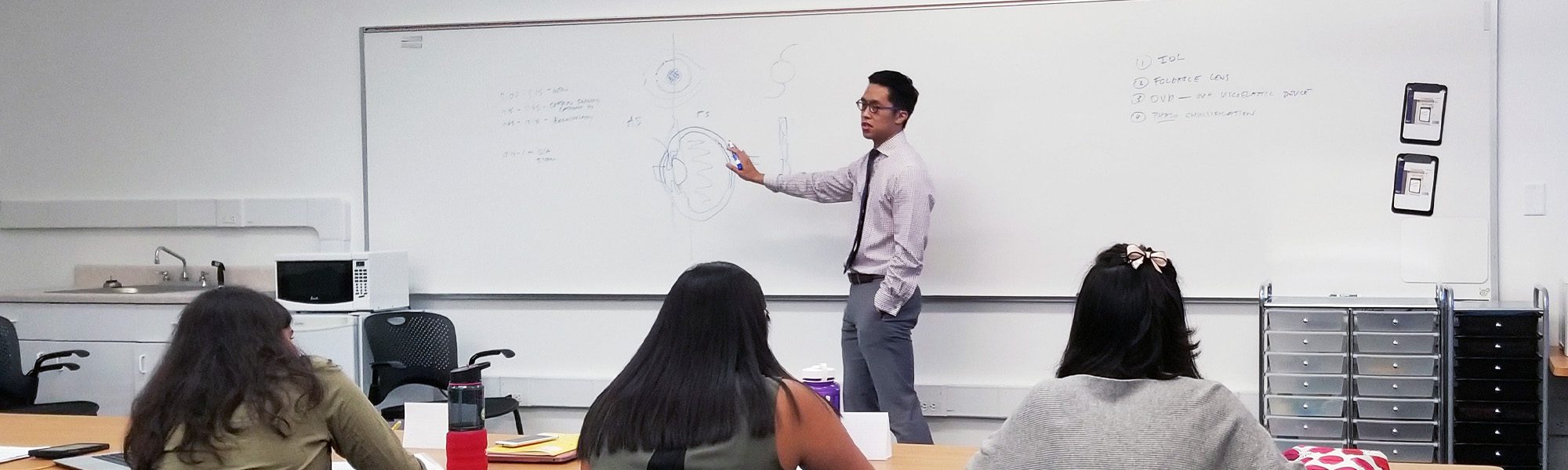 Christopher Sales presents to student about ophthalmology and visual sciences.