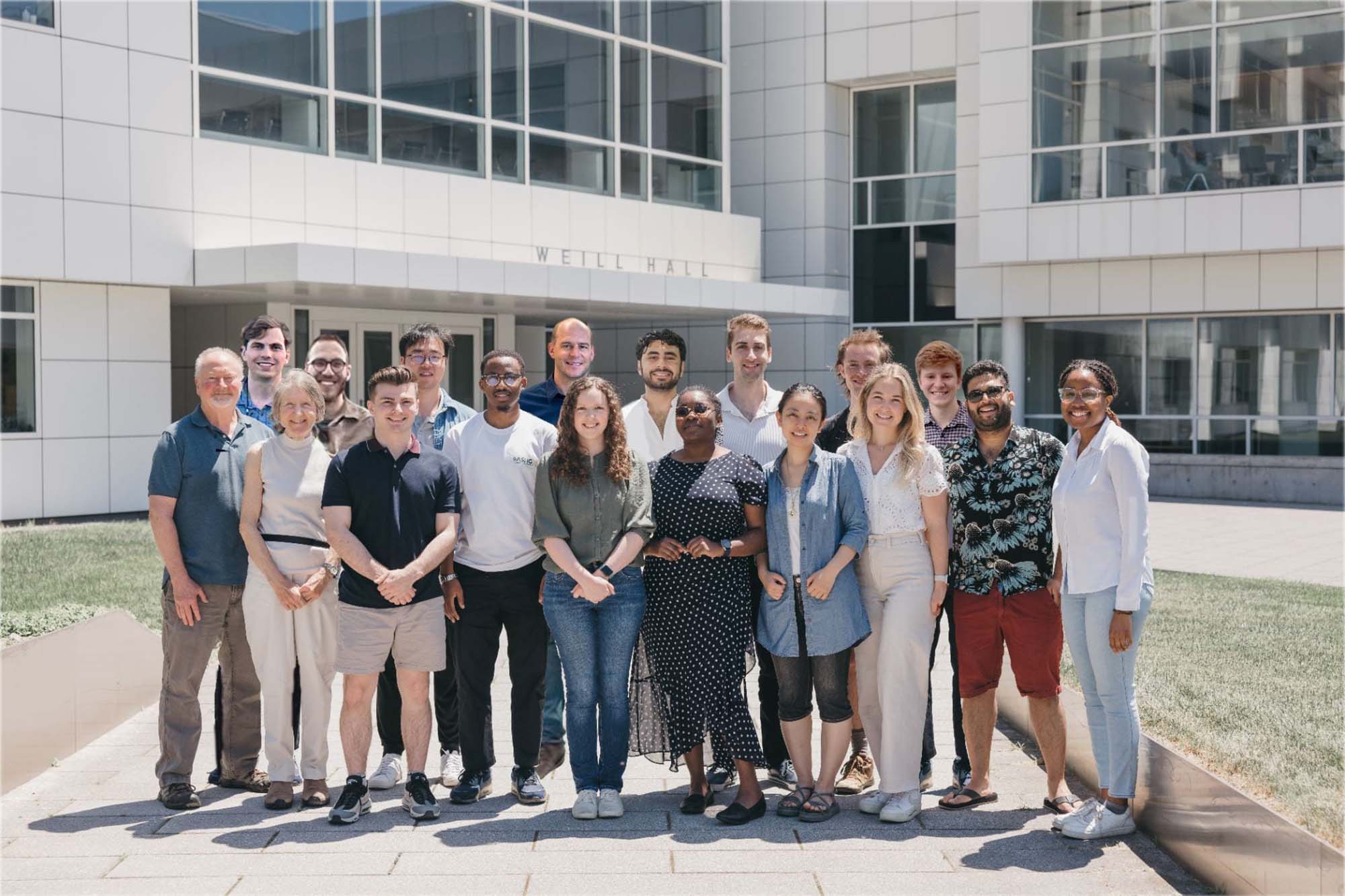 Iwijn De Vlaminck Lab group stands together outside Weill Hall summer.