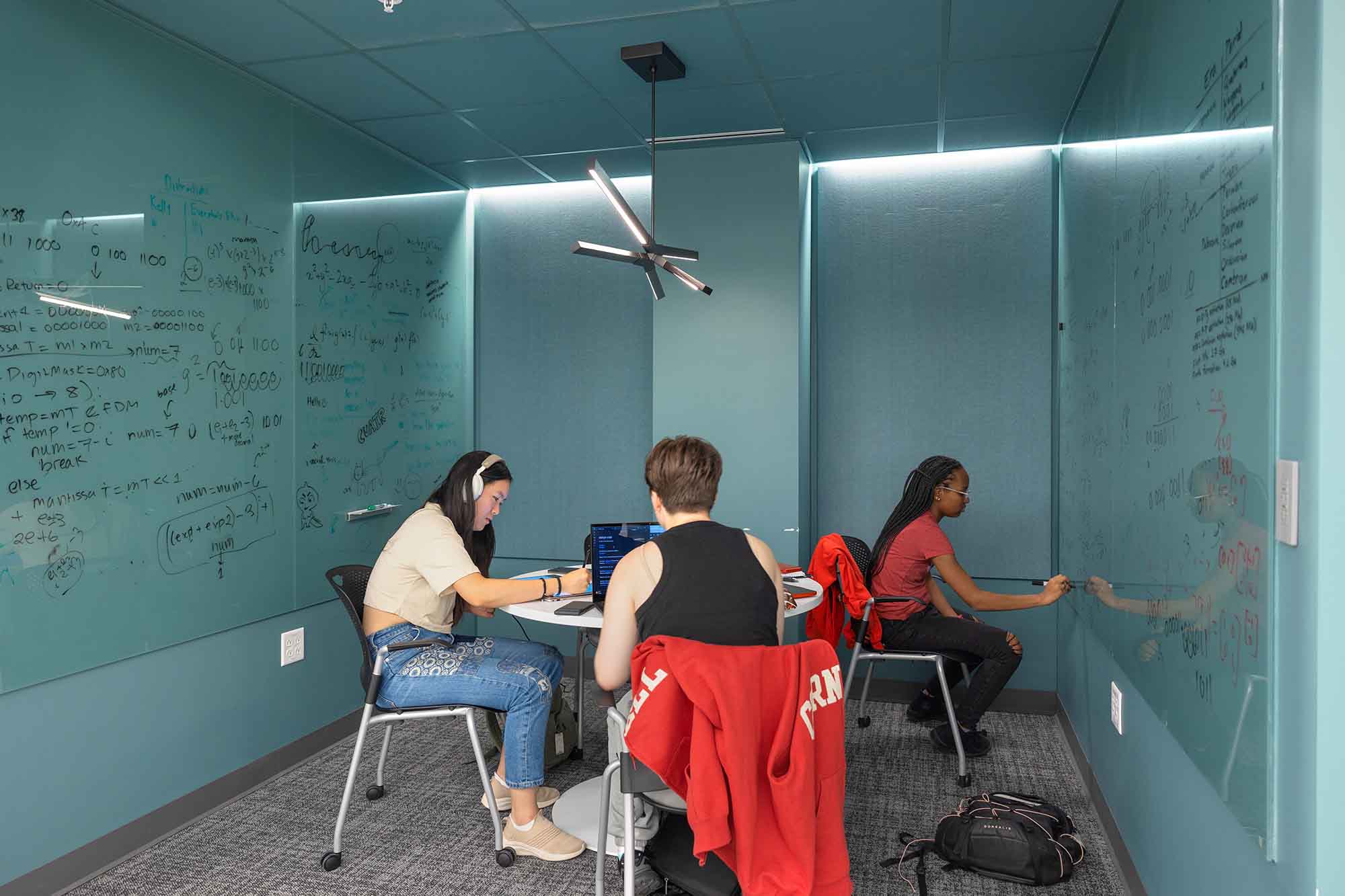 Students work on a project together in a study space in Tang Hall.