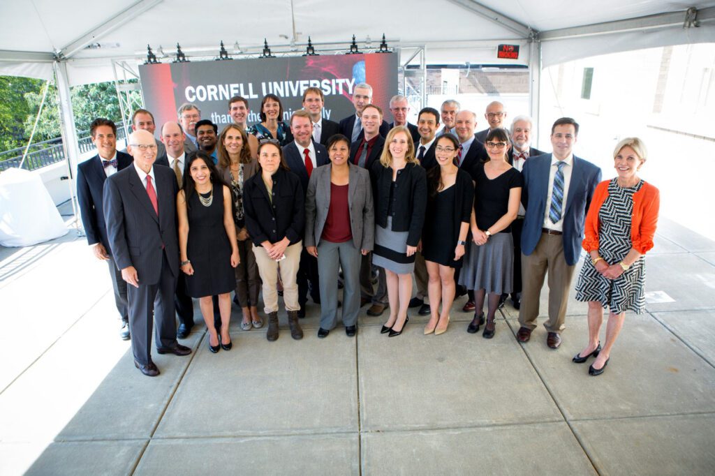 Nancy E. and Peter C. Meinig stand with biomedical engineering faculty  in 2016.