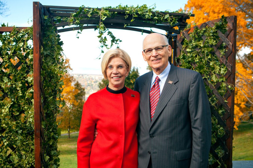 Nancy E. and Peter C. Meinig stand in front of trellis.
