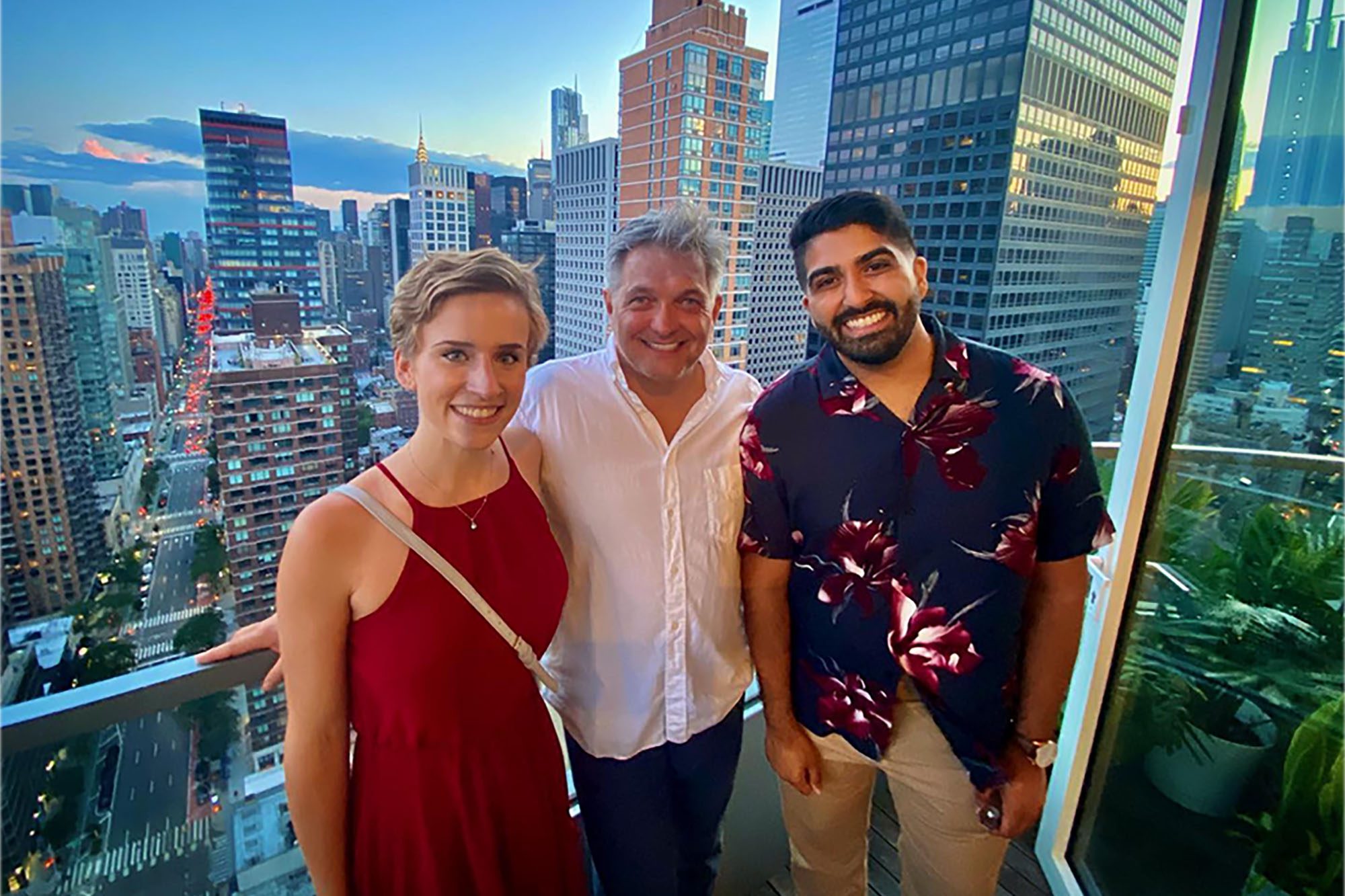 Roger Hartl with Ph.D. summer immersion graduate students stand together with New York City skyline behind them.