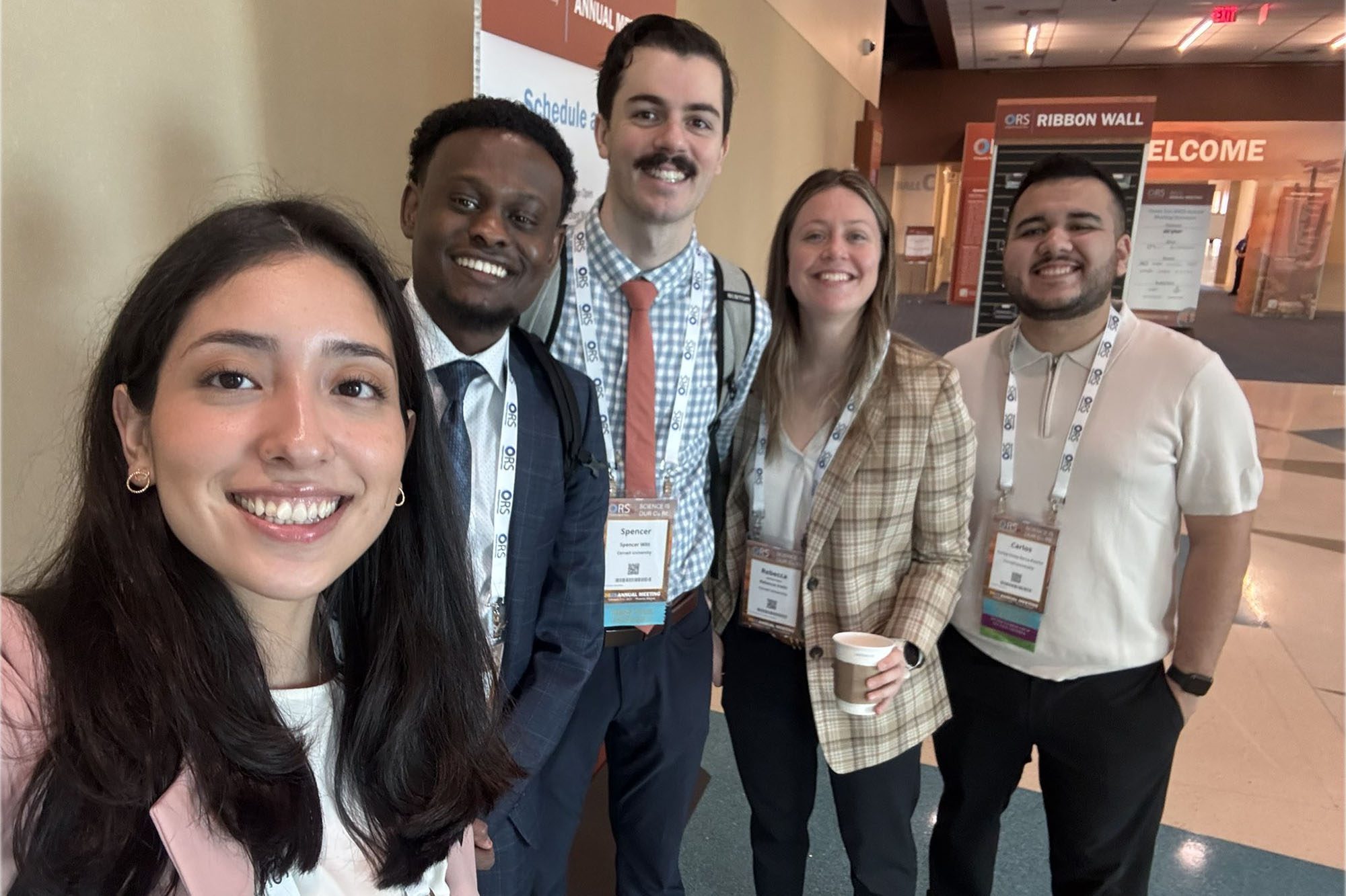 Graduate students stand together attending ORS meeting bone research.