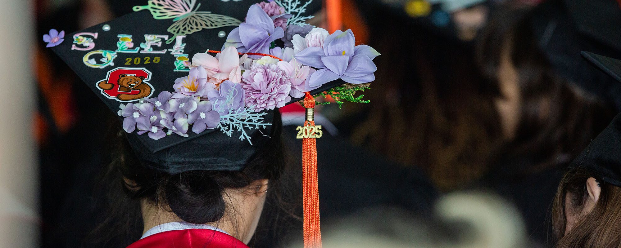 2025 graduate cap decorated with flowers.