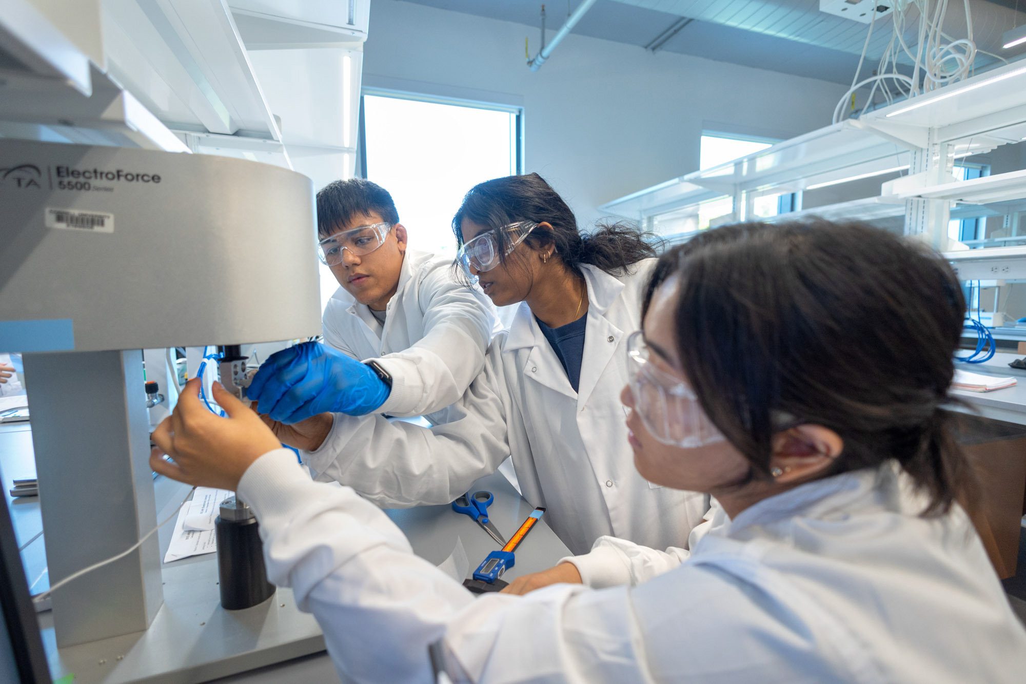 Students working with biomechanics equipment in a Tang Hall classroom.