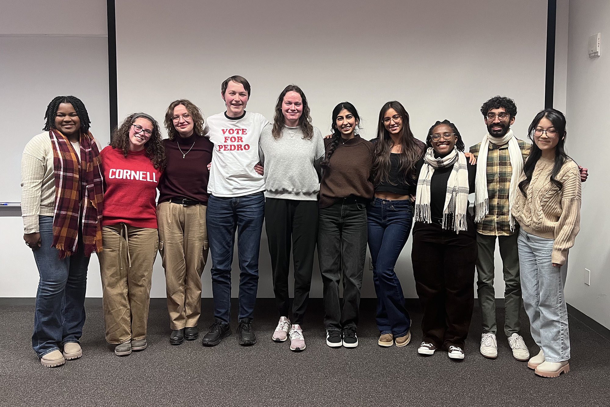 BMES graduate student group leadership stands together in a line in Weill Hall classroom.