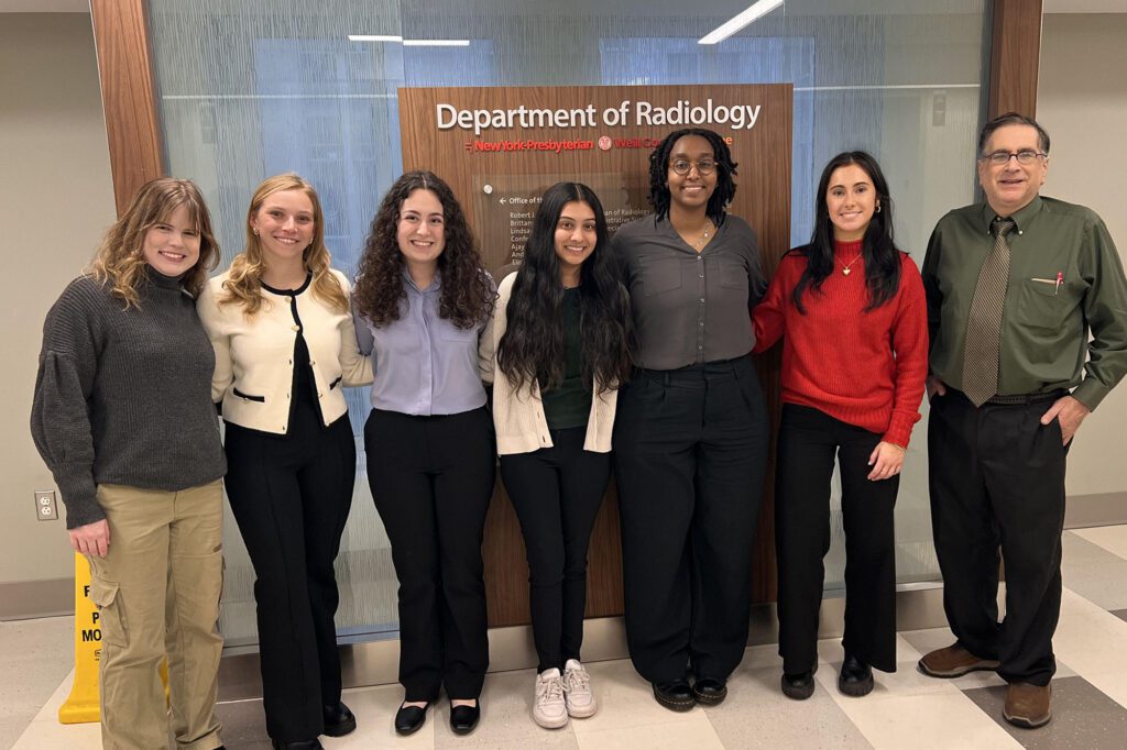 Undergraduate clinical immersion students standing with Jim Antaki in front of Weill Cornell Medicine Radiology sign.