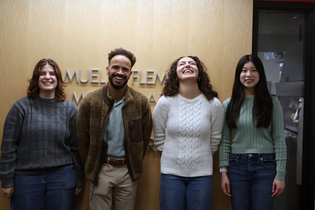 Jeremiah James stands with undergraduate mentees Stephanie Fingerman, Lydia Lehkal and Emma Leung outside their Olin Hall lab.