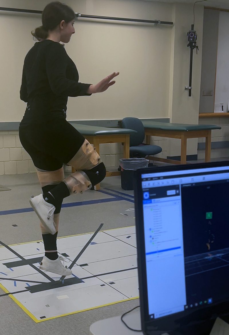 Slavett completing a hopping lab in BME 3410: Systems Mechanobiology using motion capture technology.