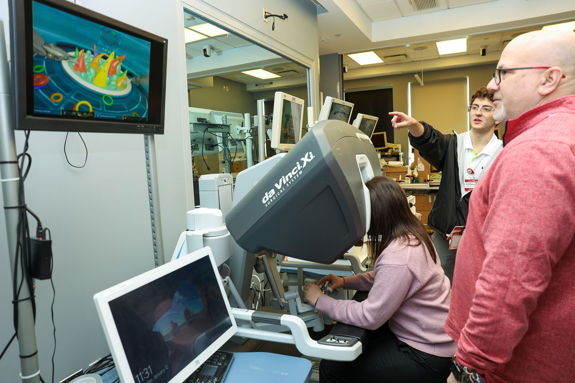 Undergraduate clinical immersion students works with medical equipment and staff in hospital.