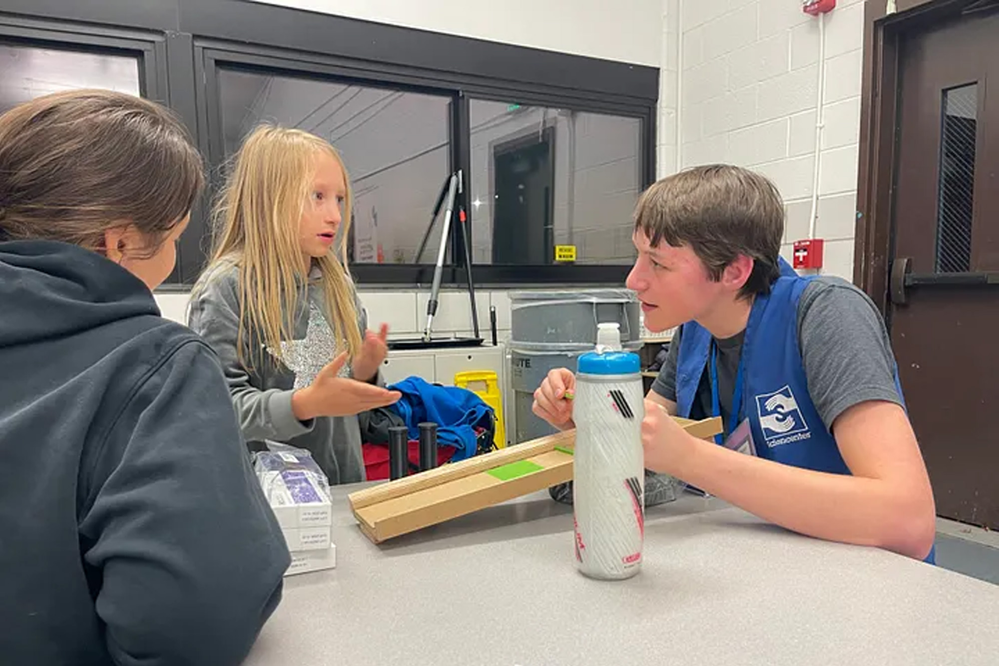 A graduate student talks to a child about a bio exhibit prototype at the Ithaca Sciencenter.
