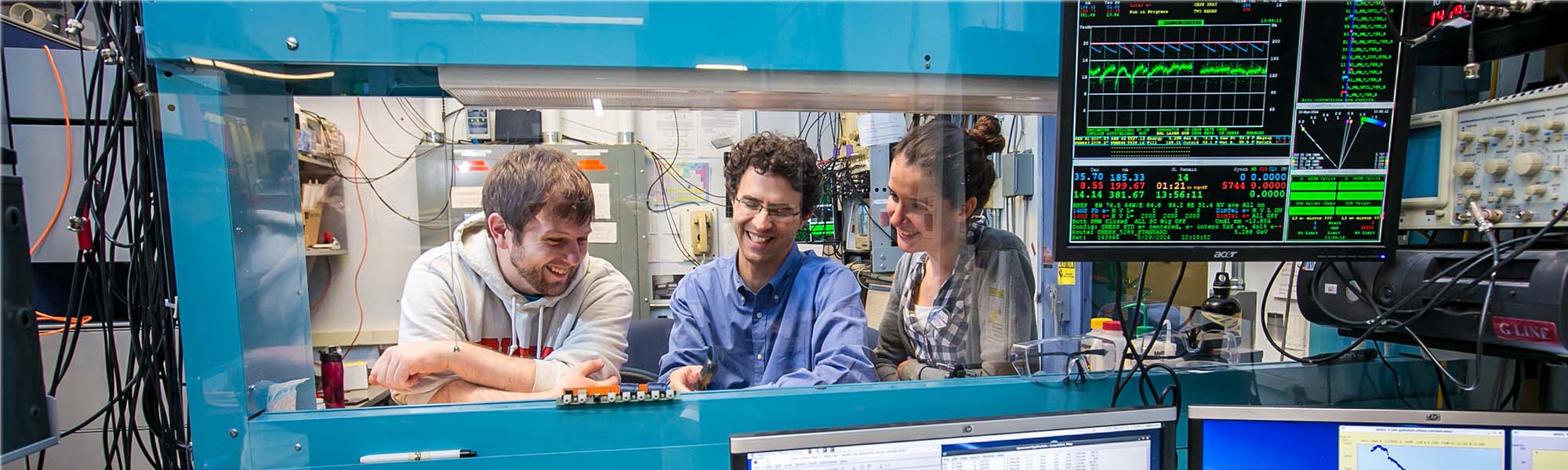 Students work with equipment together at the Cornell High Energy Synchrotron Source (CHESS) facility.