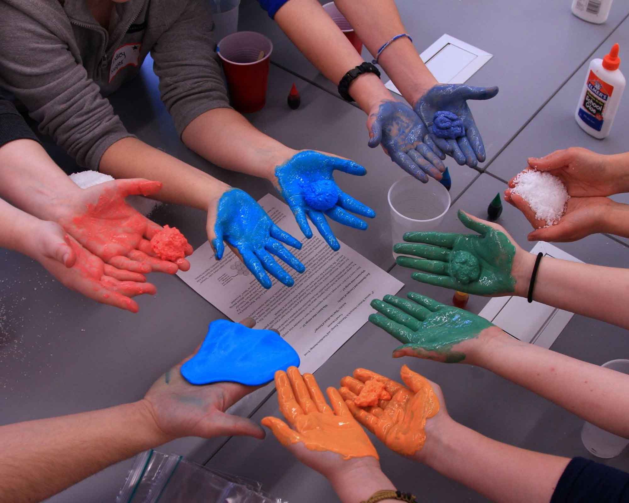 CBE women graduate student outreach event painted palms in various colors.