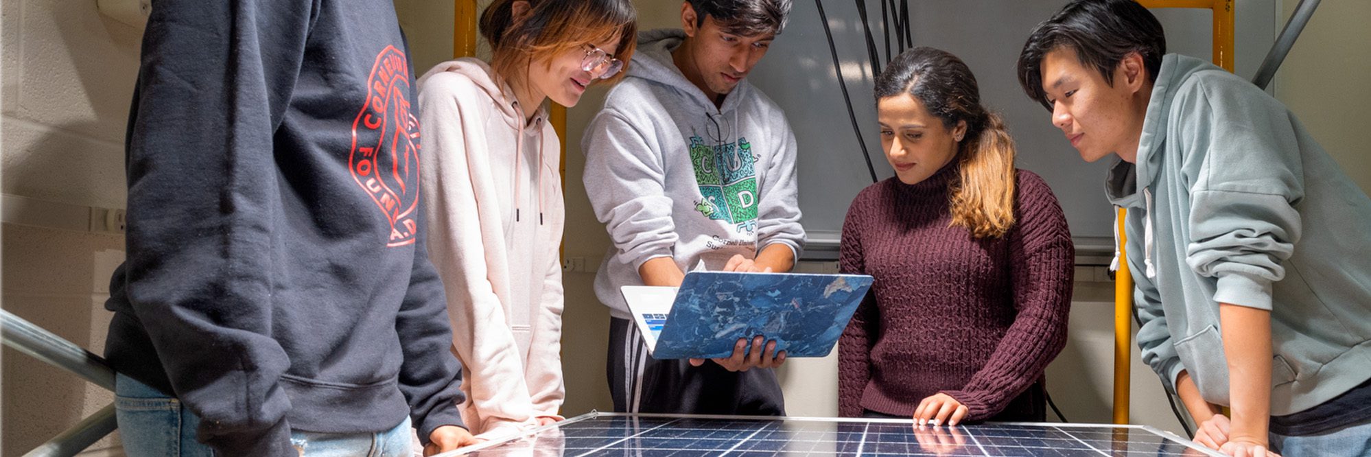 MEng Student work together at laptop.