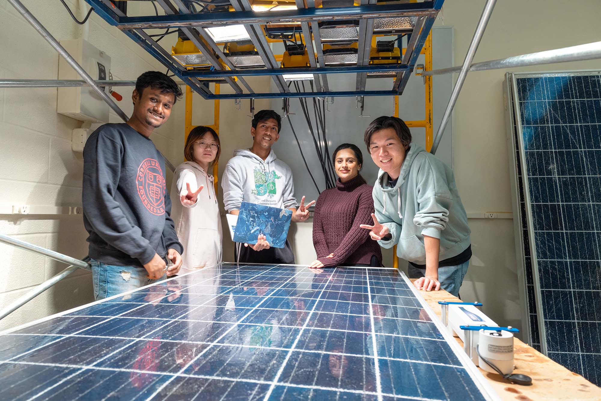 M.Eng. students work together to decide how to refurbish one of the Solar Panel Reboot team’s broken photovoltaic boards.