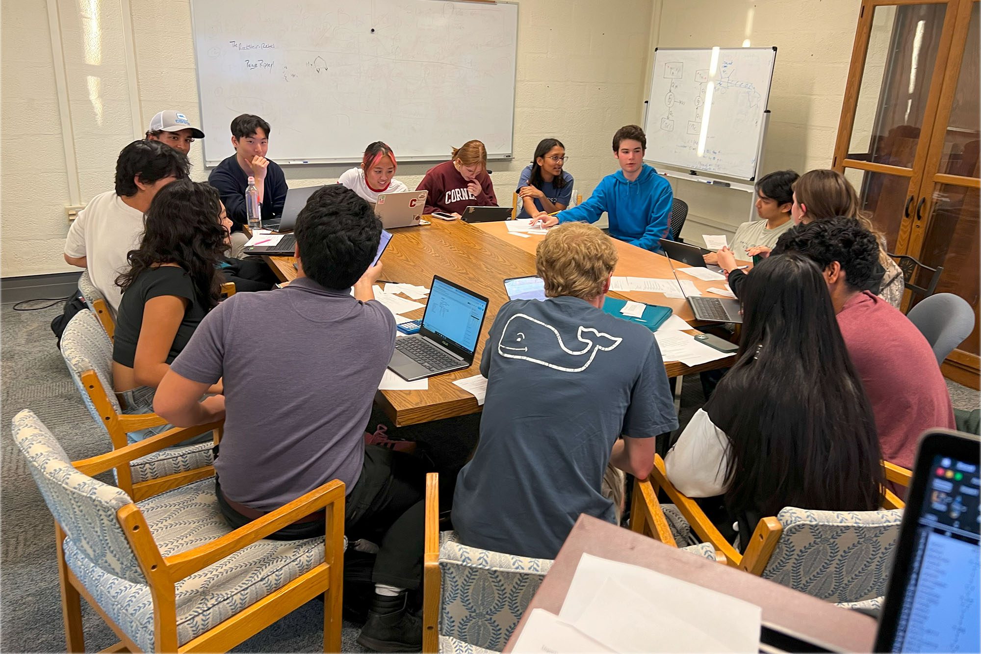 Undergraduate students in active learning initiative ALI classroom sit working at a table