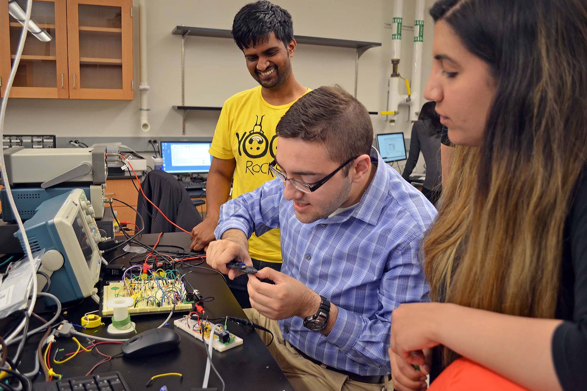Students working with electronics in the lab of Warren Zipfel.