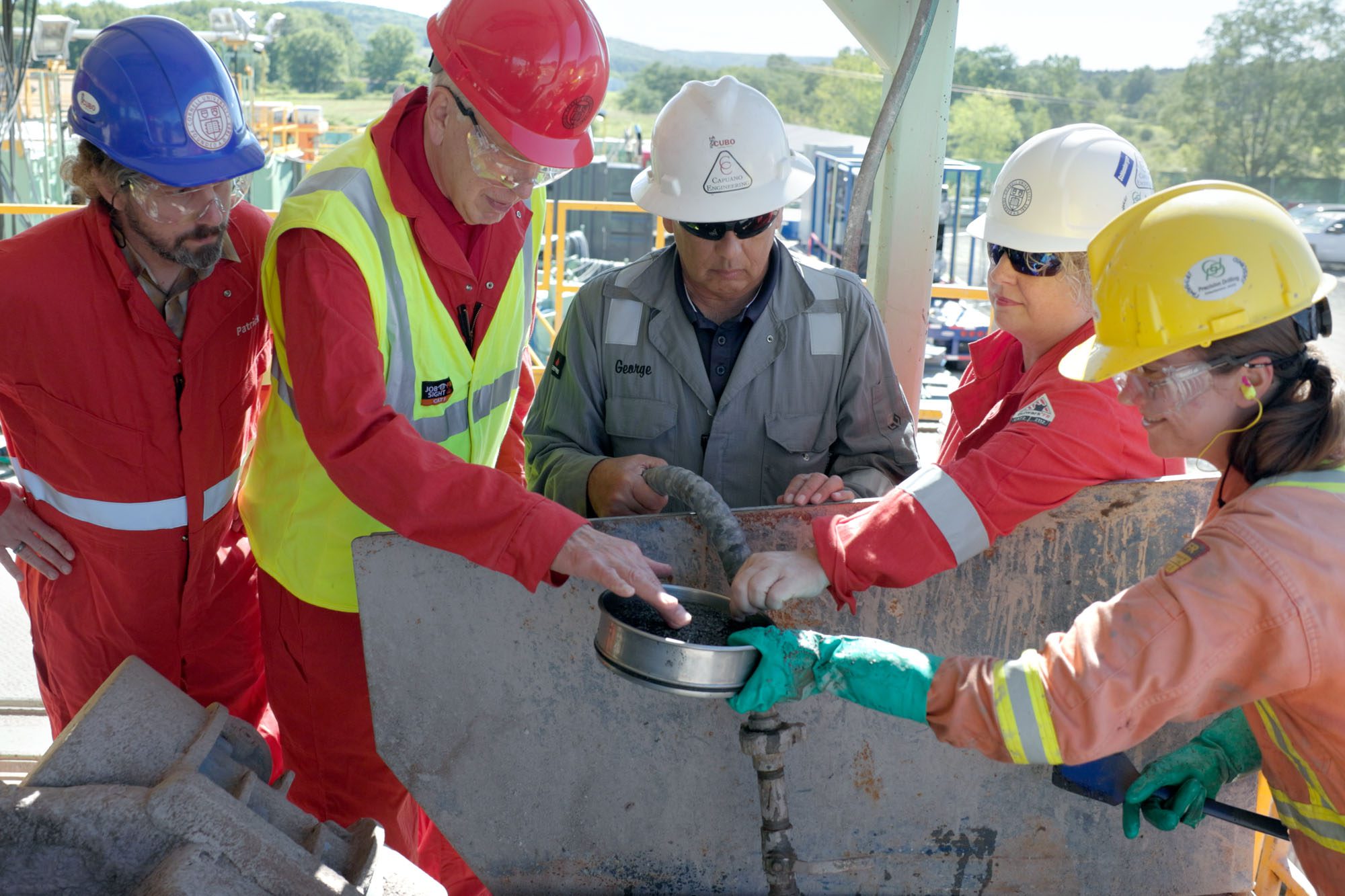 Cornell faculty, including Professor Jeff Tester (Chemical and Biomolecular Engineering), staff, and students examine sediment that was recently removed from the Cornell University Borehole Observatory (CUBO).