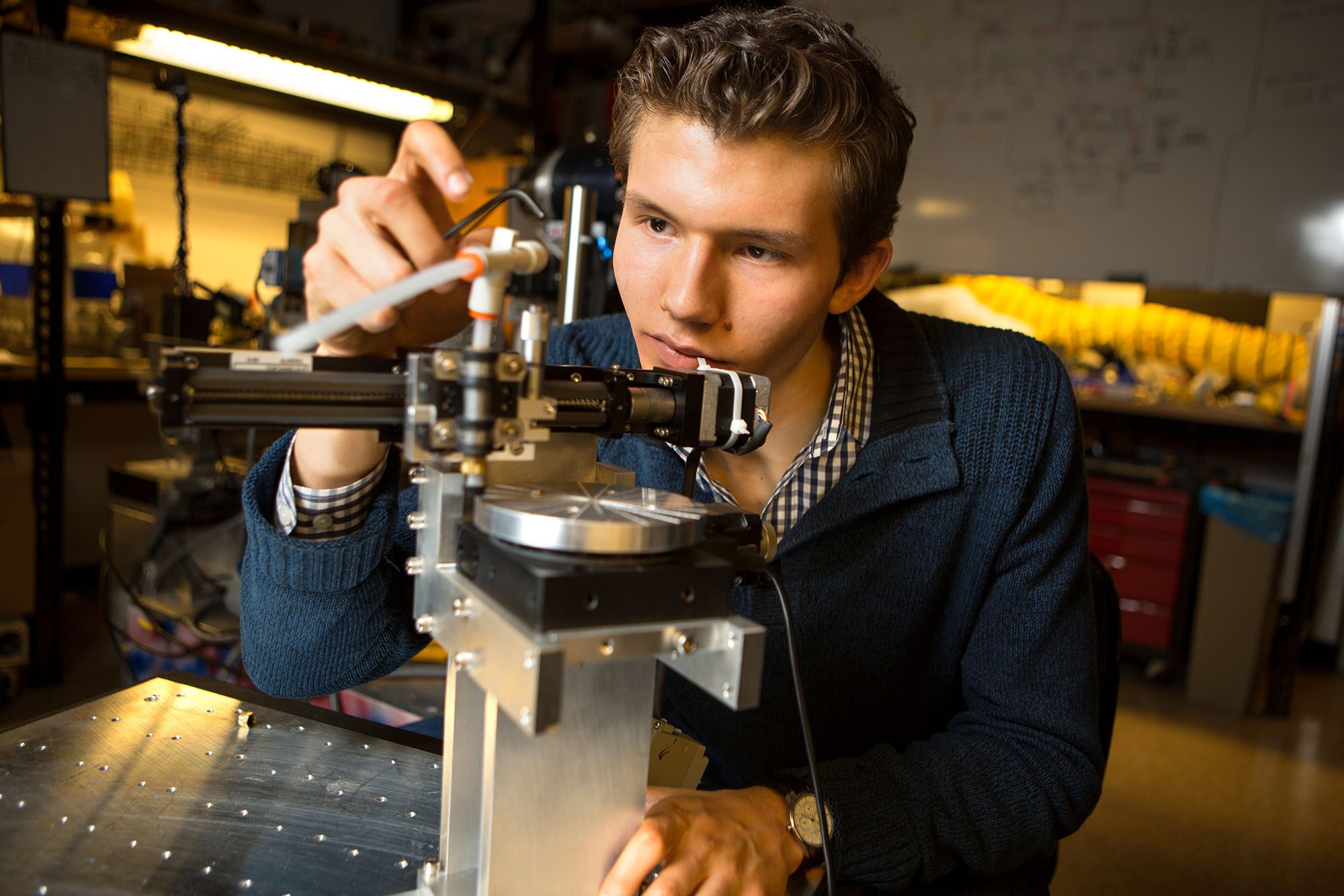Freshman physics (PHYS) student Arthur Campello works in the Cornell Laboratory of Atomic and Solid State Physics (LASSP) on a robot he designed and built himself during his time working as a research assistant at the lab.
