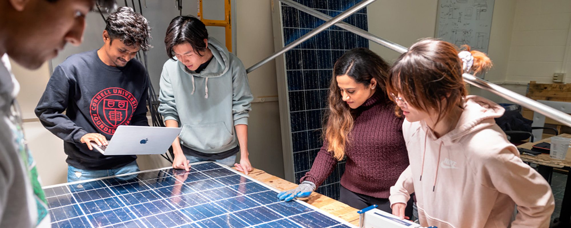 M.Eng. students work together to decide how to refurbish one of the Solar Panel Reboot team’s broken photovoltaic boards.