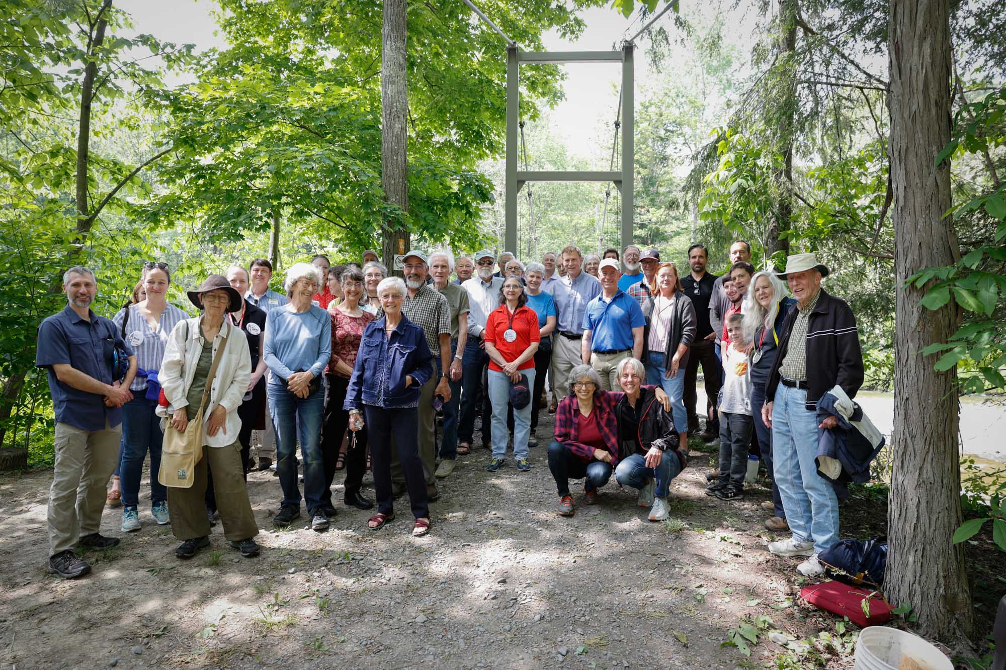 Group of alumni pose in front of Flat Rock Bridge