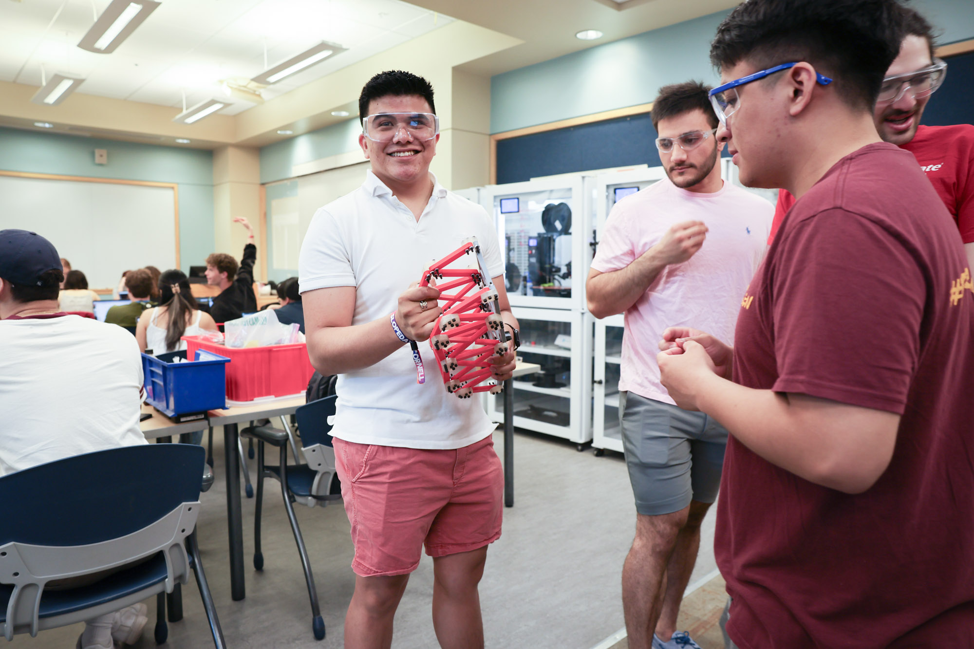 Students showing off their project in professor Ramya Nair's bridge testing class