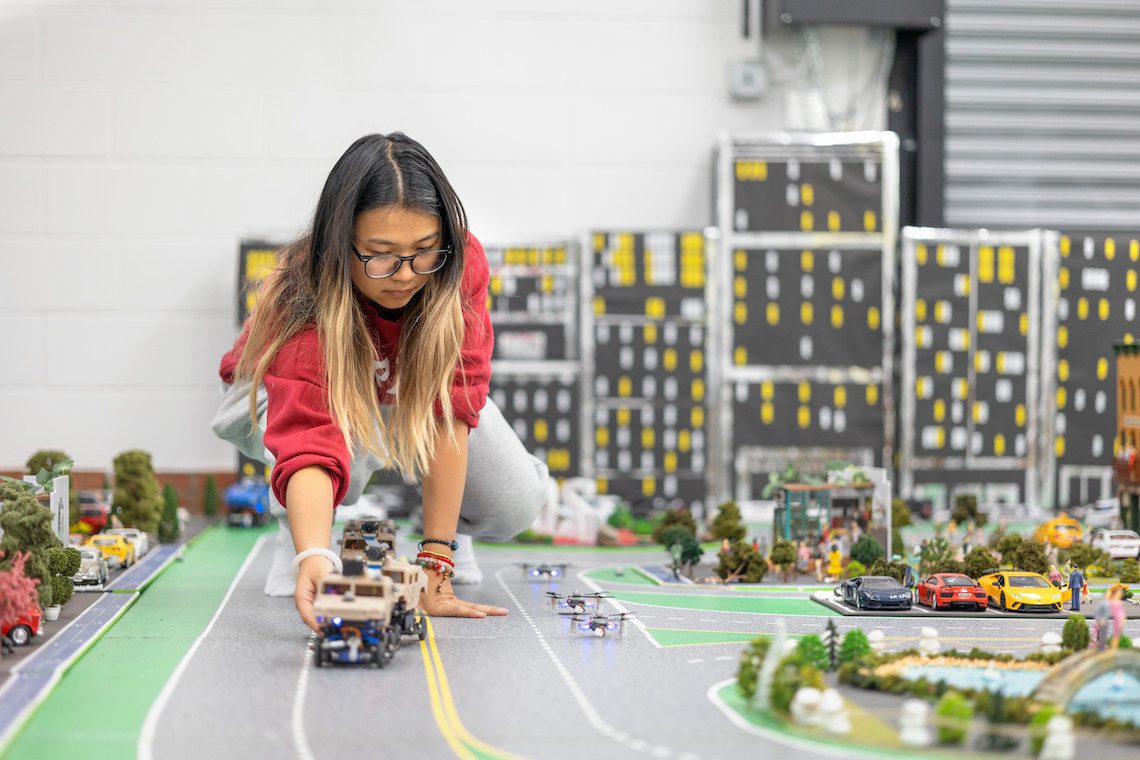 student sets a model car