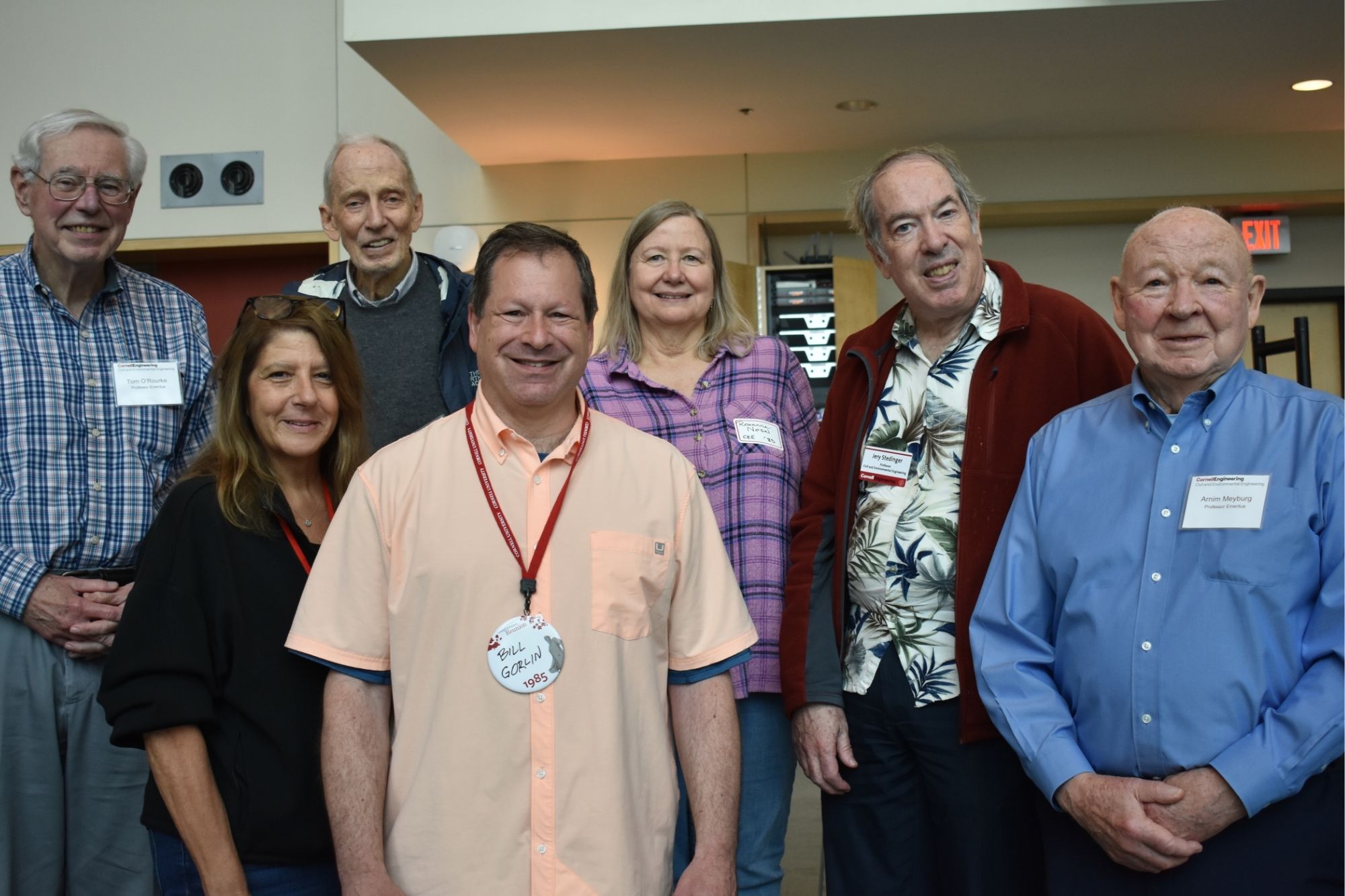 Seven alumni standing together in Duffield Hall during 2025 CEE Reunion weekend