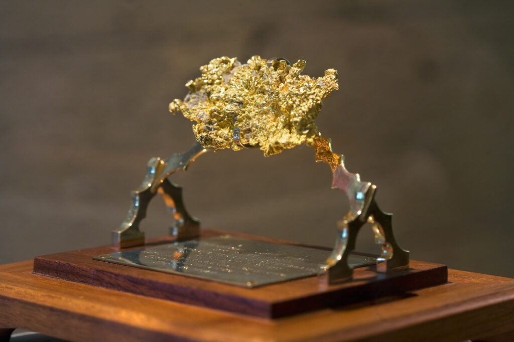 a golden mineral sample in the Timothy Heasley Mineralogical Museum