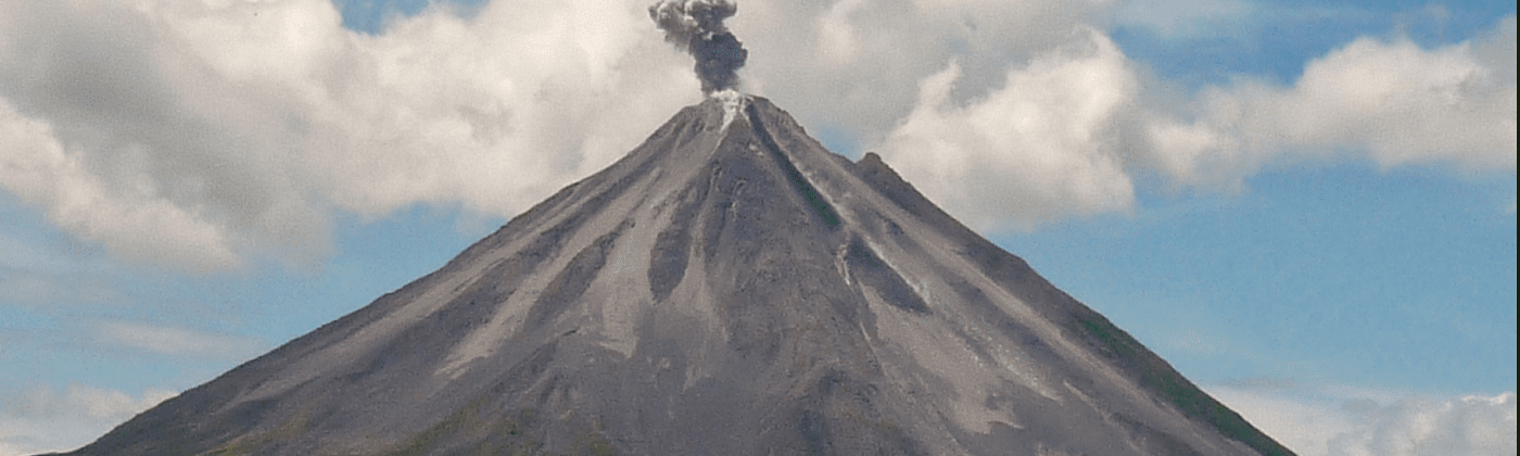 steaming top of a conical volcano