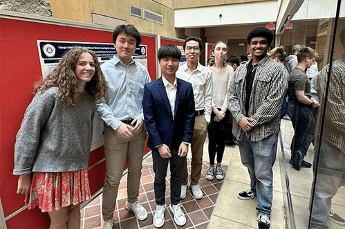 Students from the CU GeoData project team stand near a research poster in Snee Hall.