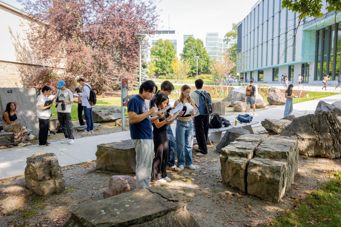 Students take notes in the Rock Park on the Engineering Quad