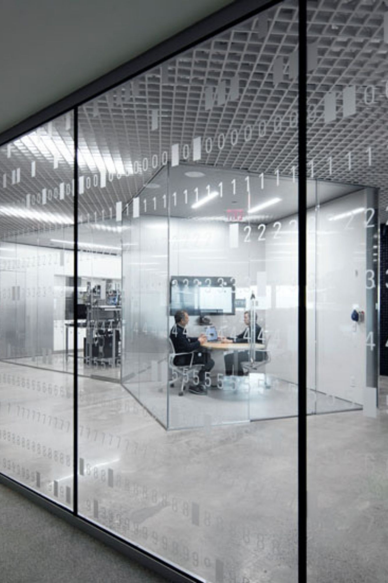 Computer systems laboratory collaboration space with glass windows with decals of code on them