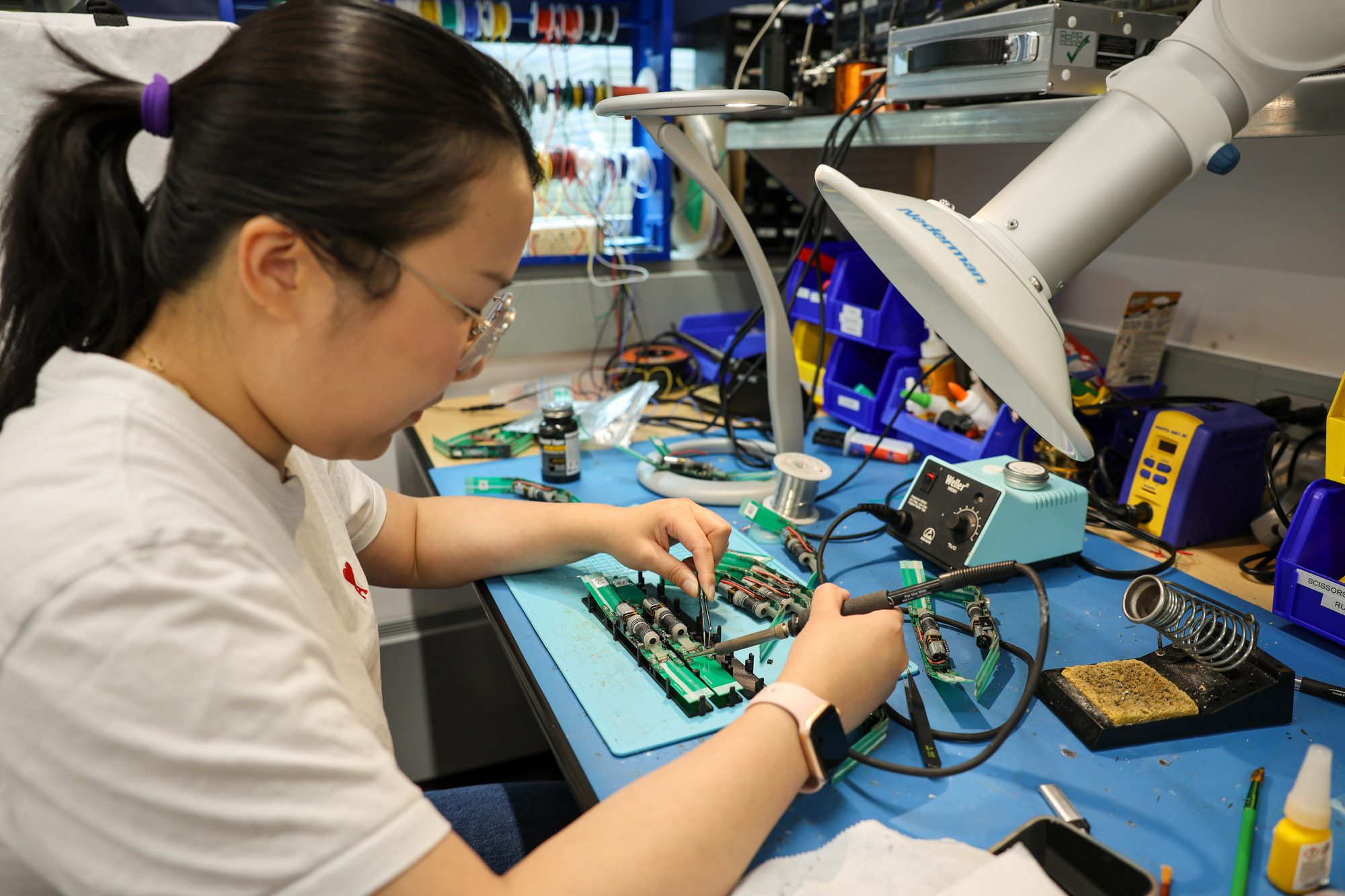 A student solders small parts in Kirstin Petersen's lab