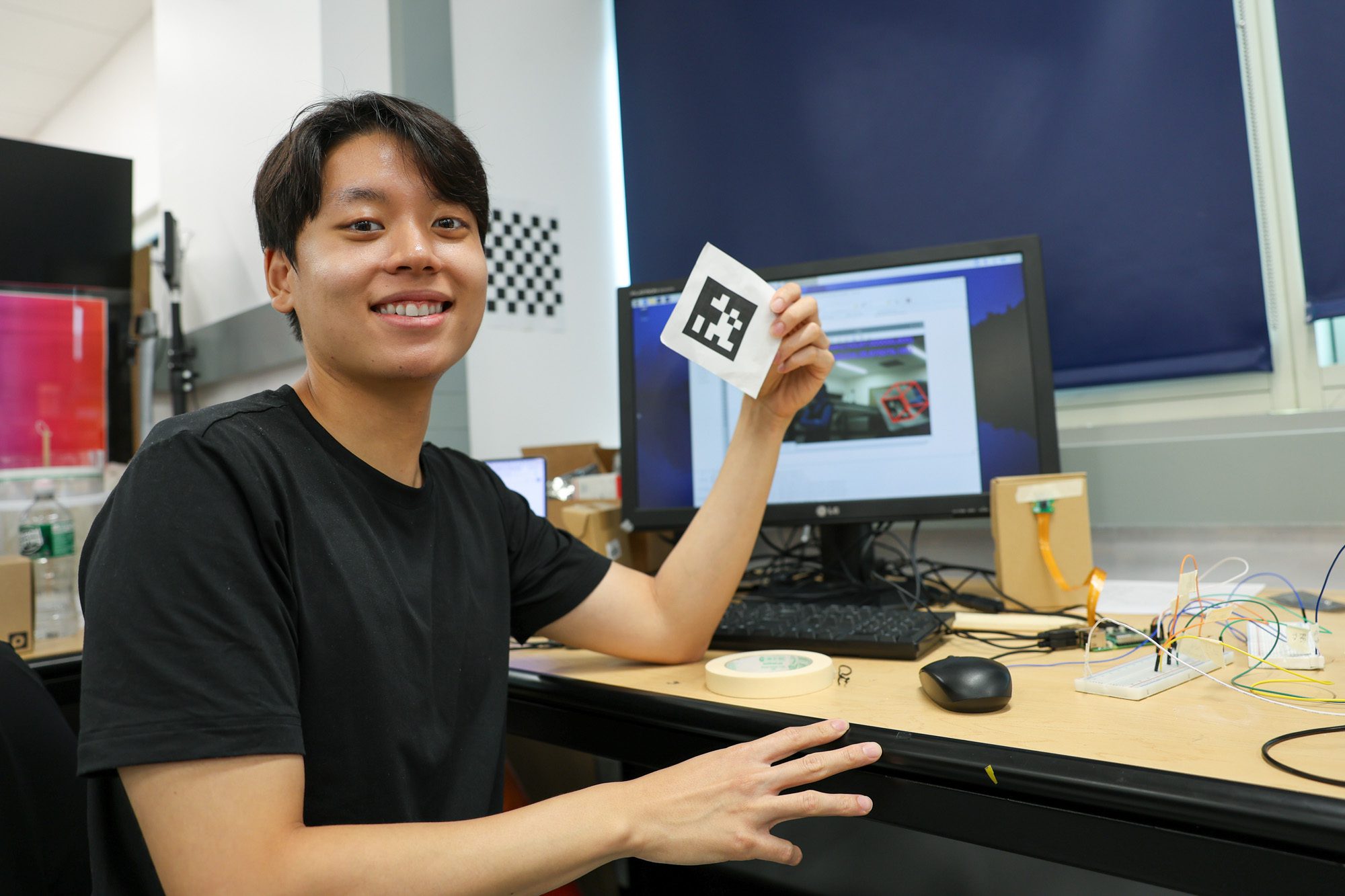 A student shows what their working on in Kirstin Petersen's lab