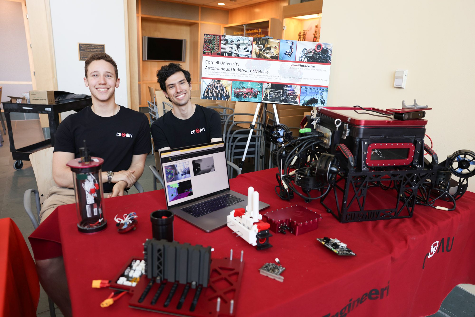 Students from the Cornell University Autonomous Underwater Vehicle project team showcasing some of their robots at an event in ECE