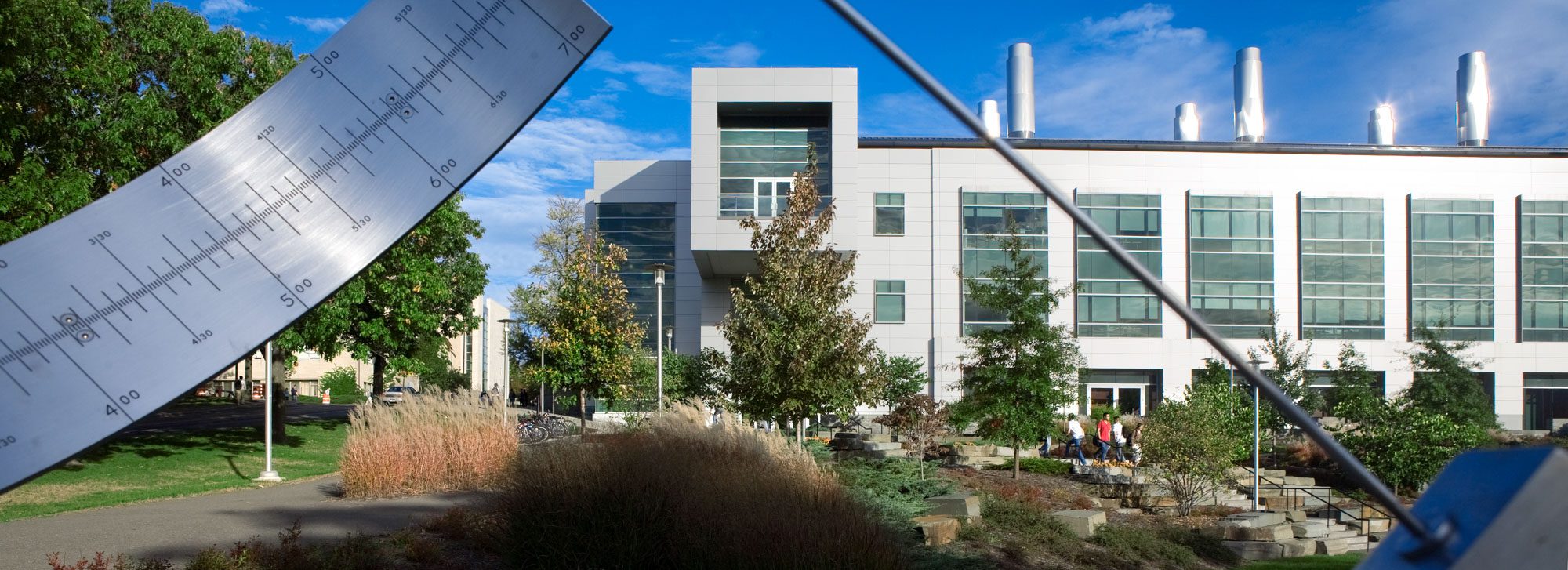 Duffield Hall on sunny day, with Pew Sundial in foreground
