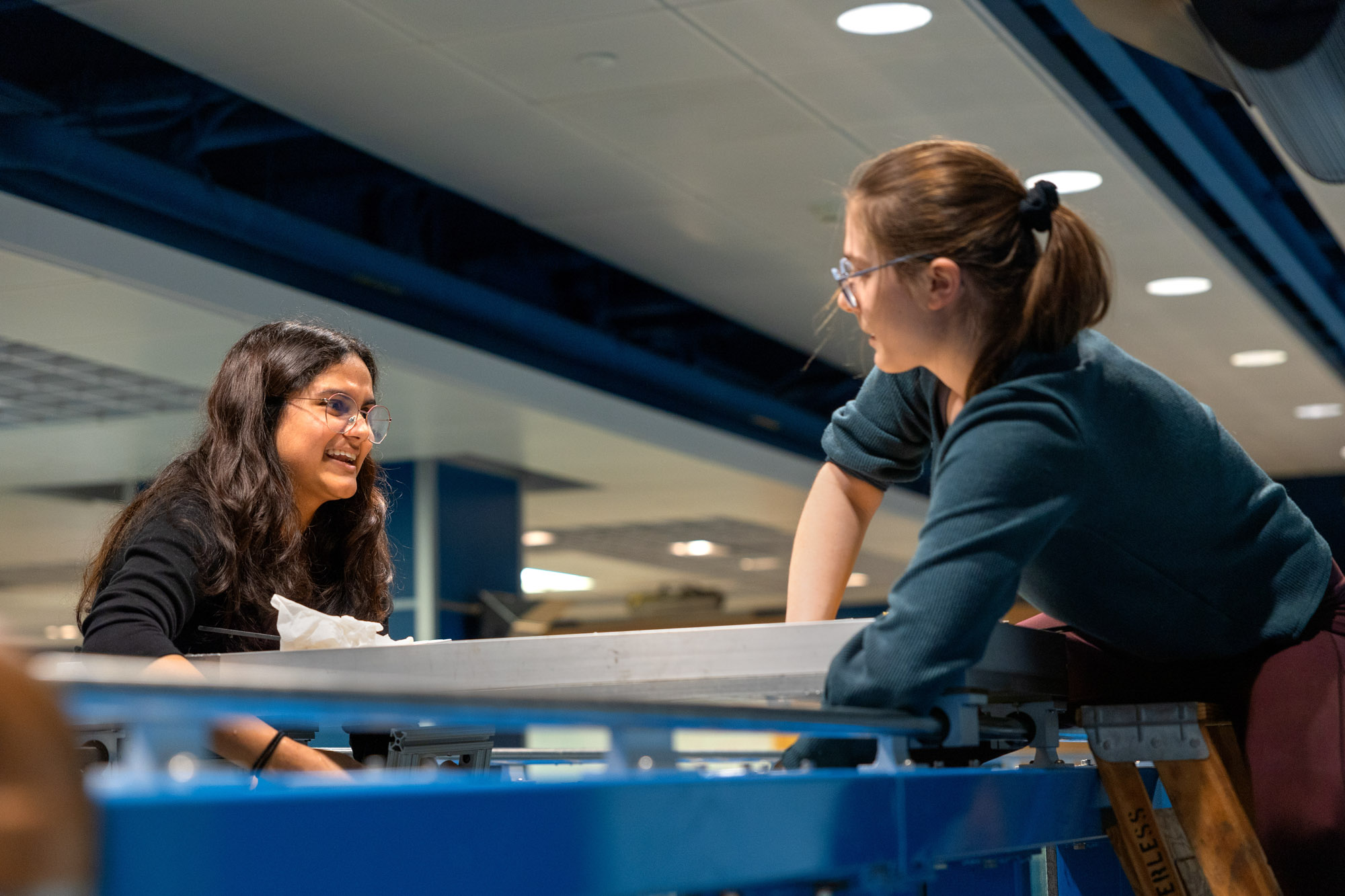 Kavya Mittha and Aisha Brundan test their wave energy conversion machine in the wave simulator tank in Hollister Hall.