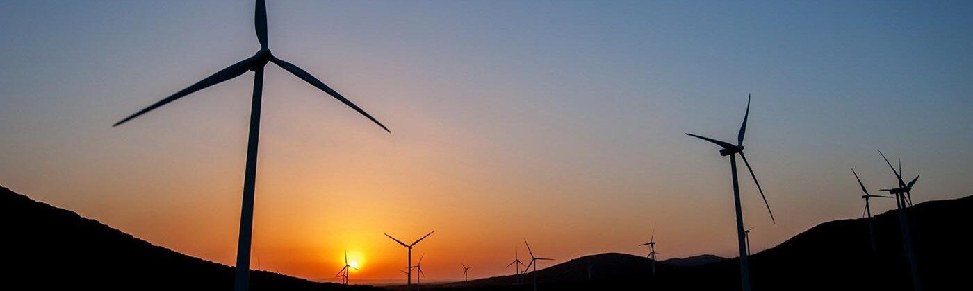 wind turbines against a sunset sky
