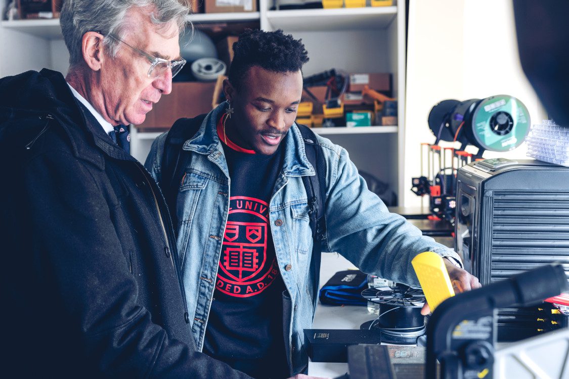 Bill Nye and Smith Charles talk about various mechanical devices sitting on a table