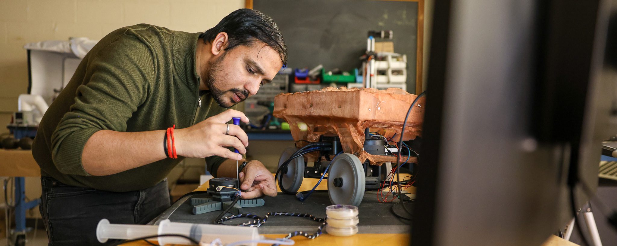 Researcher working with a soft robot in a lab